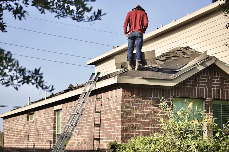 Professional roofer working on a residential roof in Hance Point Estates